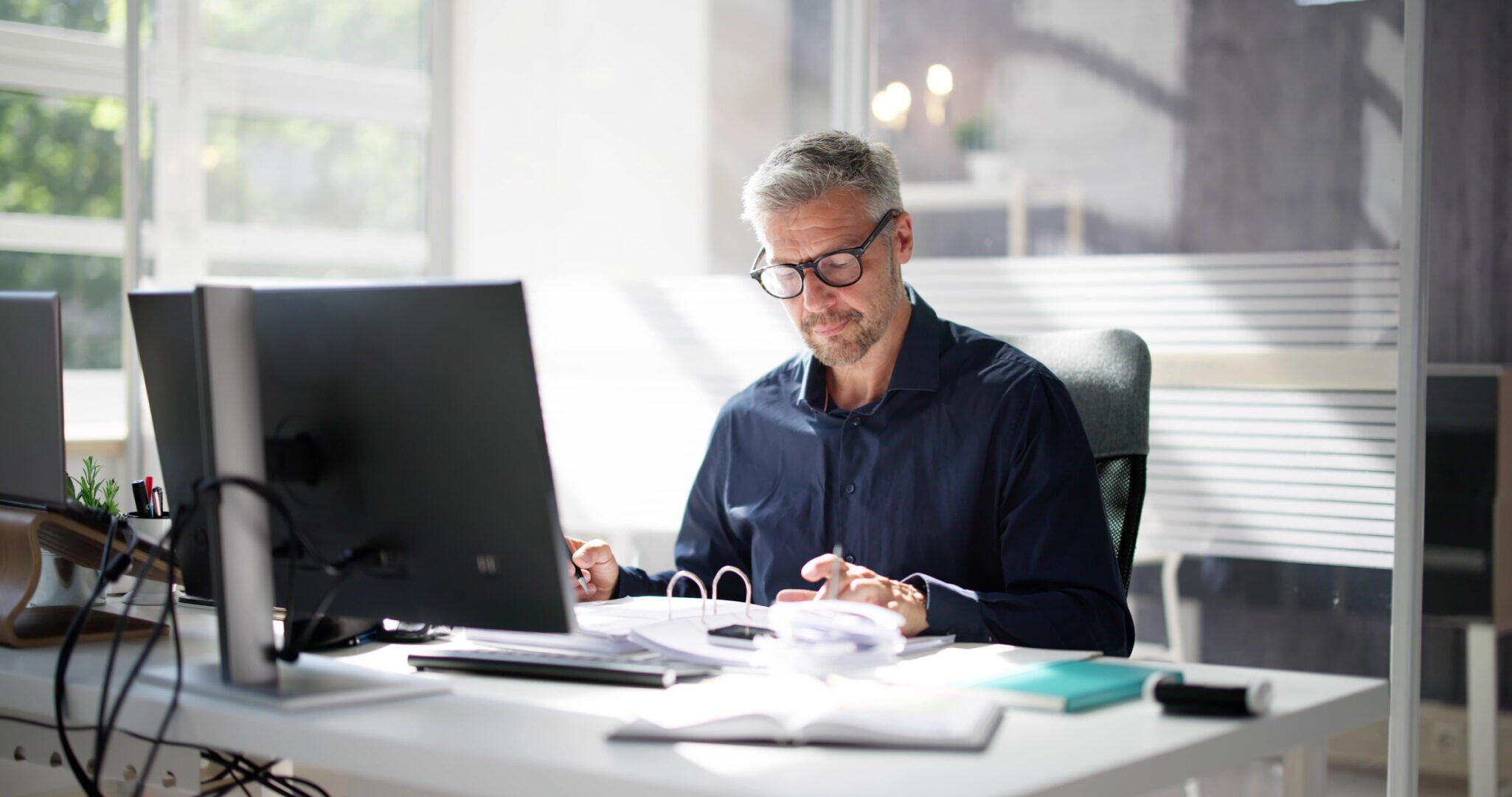 man-working-at-desk-scaled