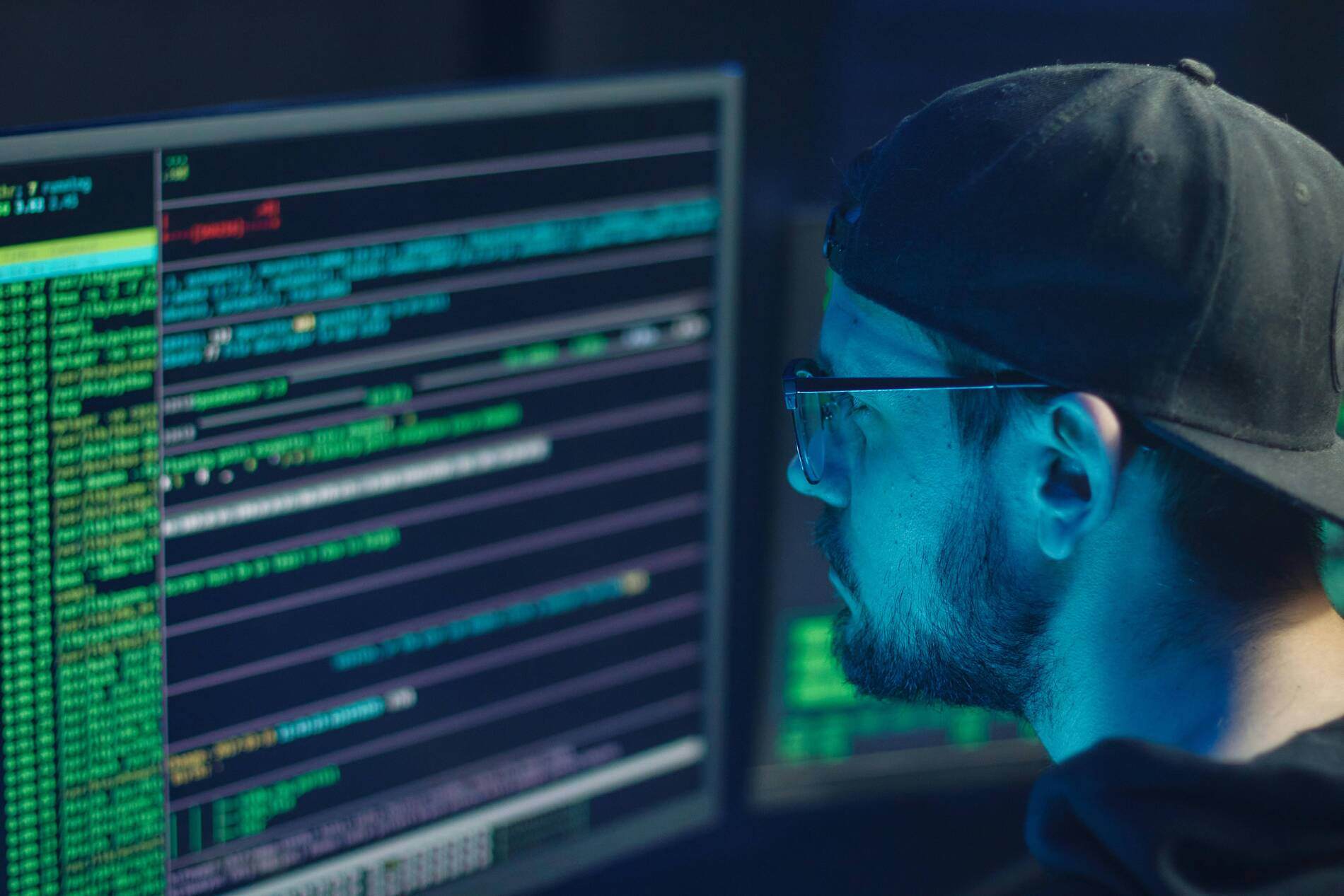 man looking at code on screen