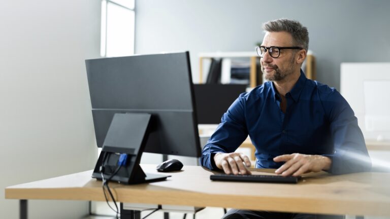Businessman Using Business Computer In Office Or Workplace